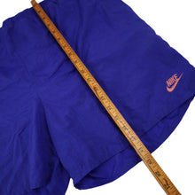 Load image into Gallery viewer, Vintage 90s Nike Big Spellout Swim Trunks. Features 90s gray tag - L